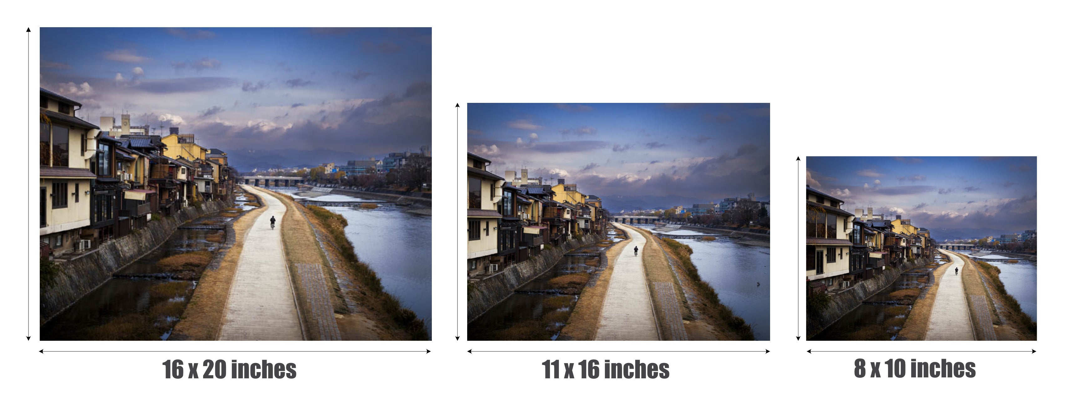 Three framed or mounted wall art prints showing a river scene with buildings on the left and a lit pathway running through the center, displayed side by side with size labels: 16 x 20 inches, 11 x 16 inches, and 8 x 10 inches.